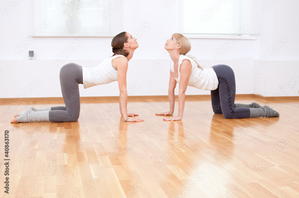 Women doing yoga exercise at gym
