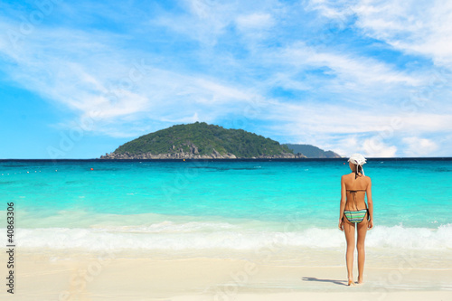 Lonely woman bikini by the sea