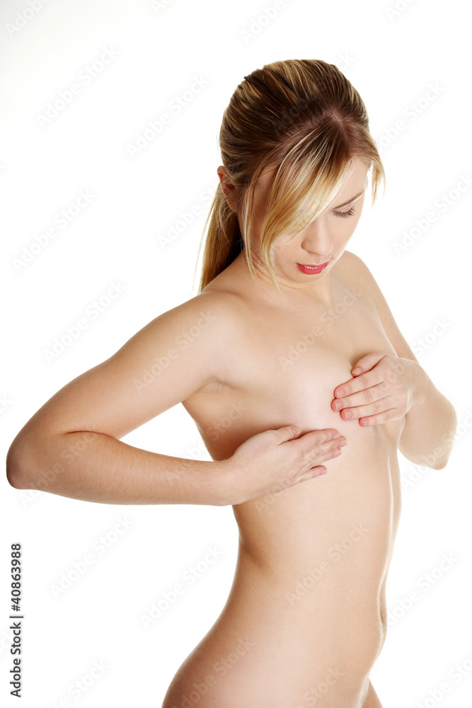 Young Caucasian adult woman examining her breast for lumps or si Young Caucasian adult woman examining her breast for lumps or si