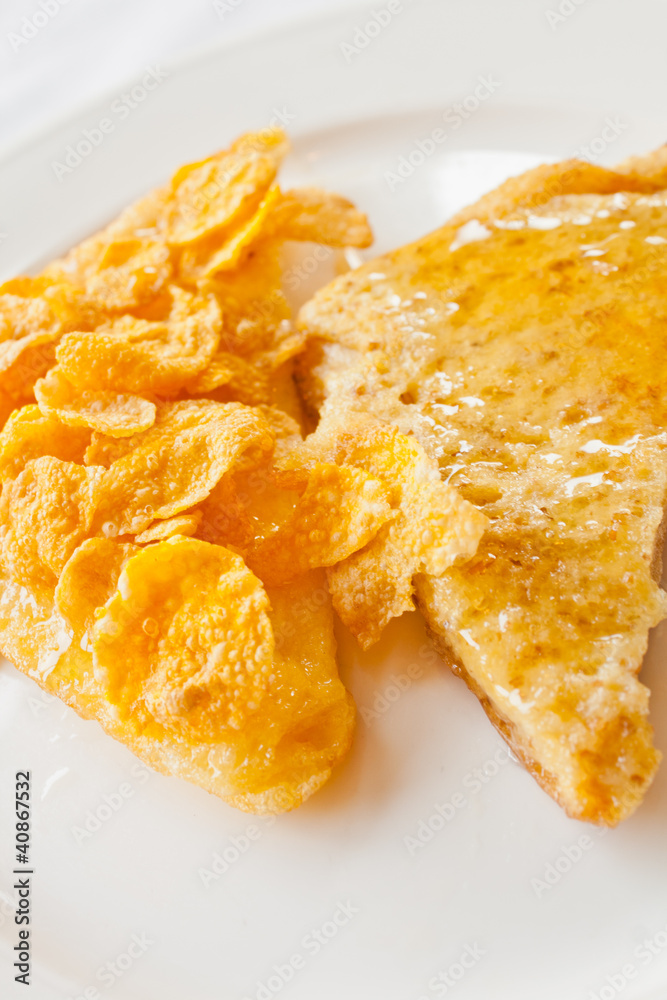 Bread topped with honey on a white dish Bread topped with honey on a white dish