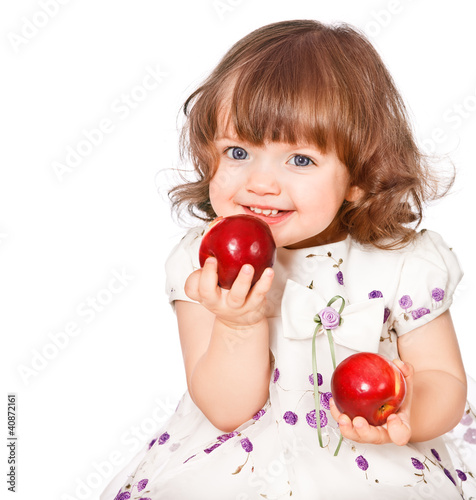 portrait of a little girl eating apples
