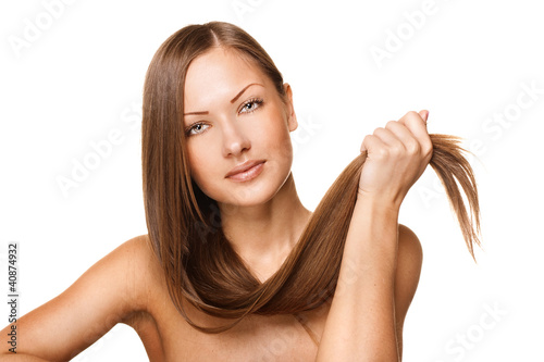 beautiful young woman holding her elegant long shiny hair
