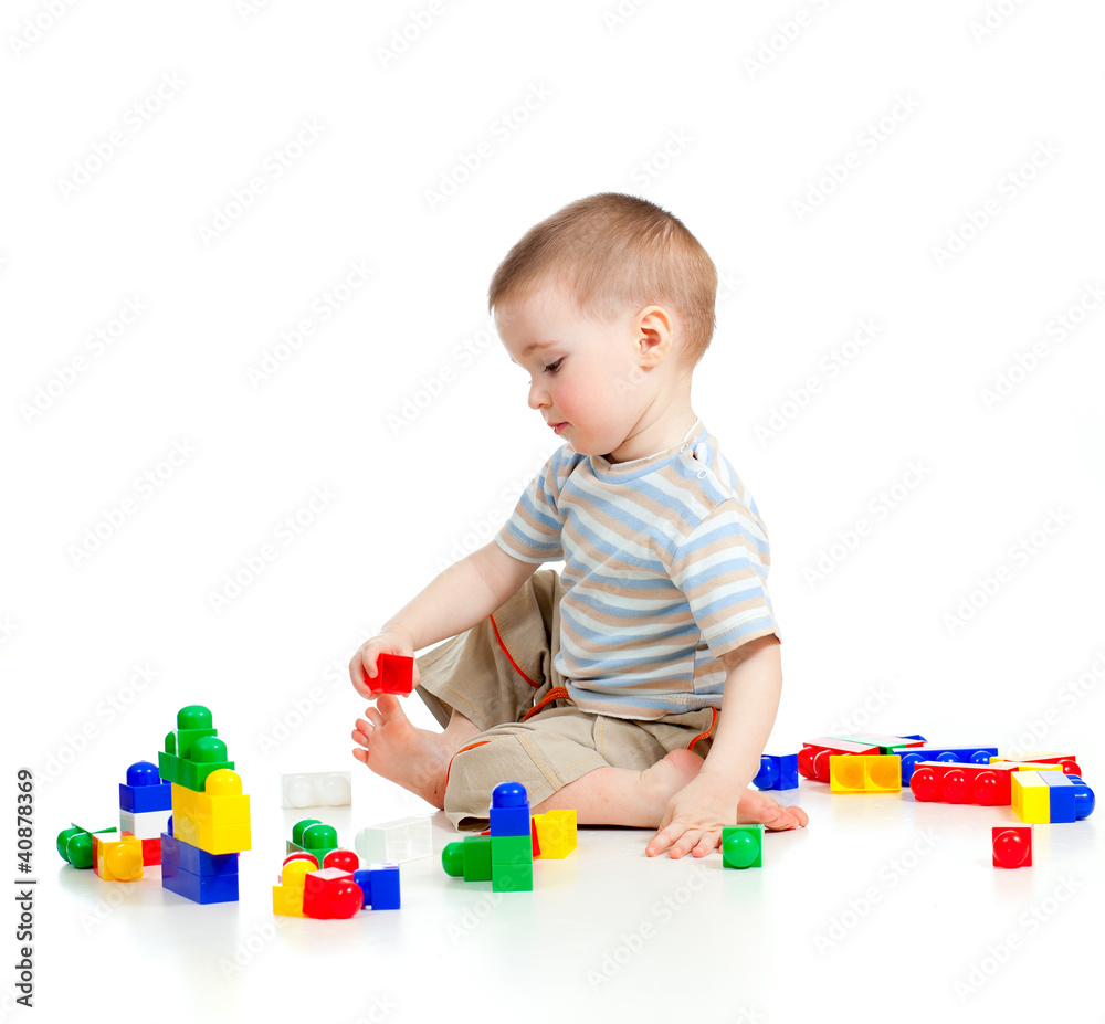 cheerful child boy playing with colourful construction set cheerful child boy playing with colourful construction set