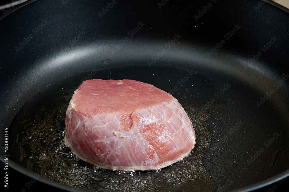 Meat roasting on a frying pan Meat roasting on a frying pan