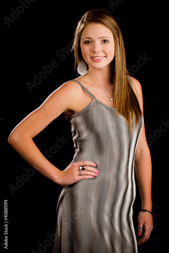 Portrait of beautiful teenage girl smiling isolated on black