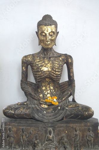 Buddha statue are suffering for become to enlightened photo