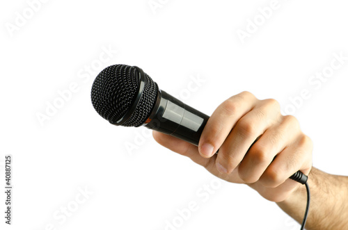 Hand holding microphone on white