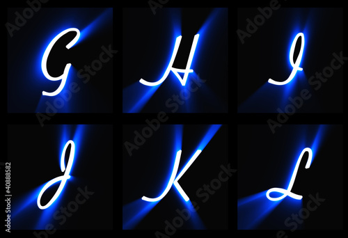 The letters on a black background in blue light