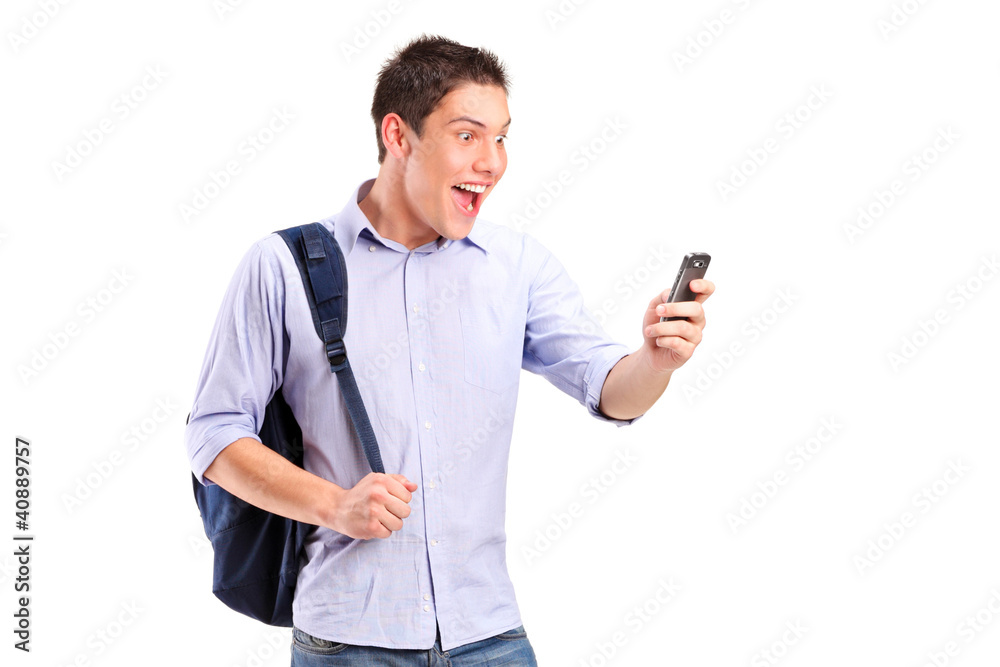 A portrait of a smiling young man looking at a cell phone A portrait of a smiling young man looking at a cell phone