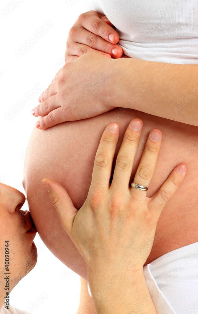 Image of happy man kissing pregnant belly of his wife