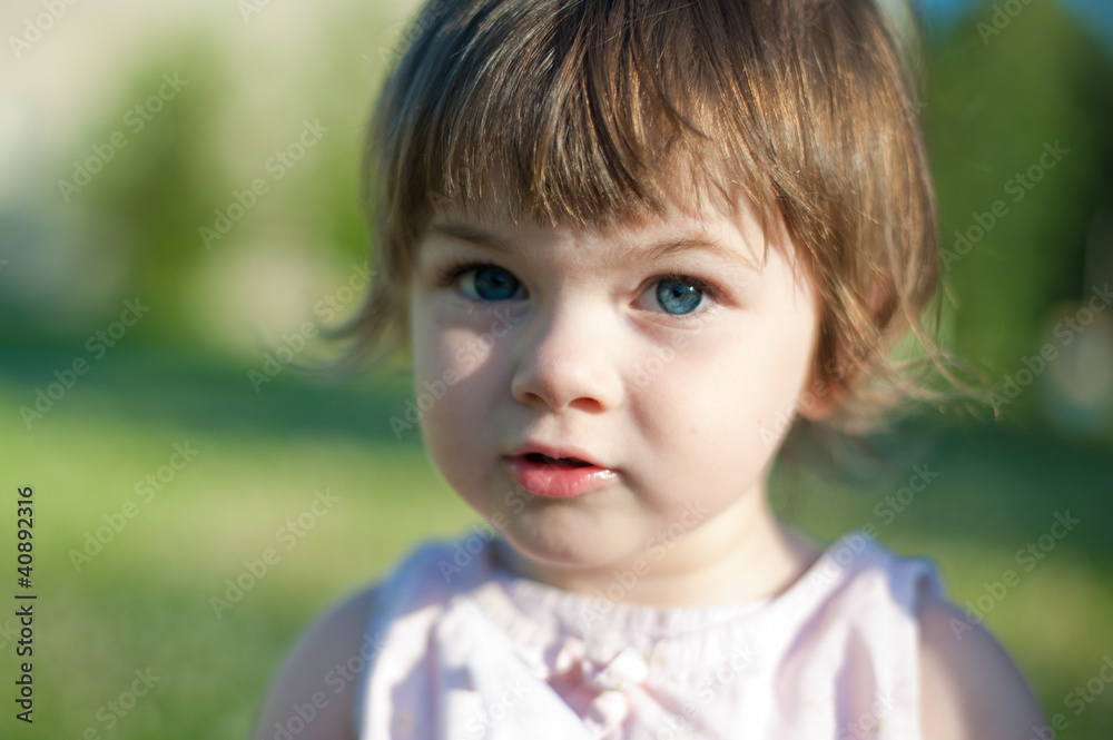 A little girl in a summer park A little girl in a summer park