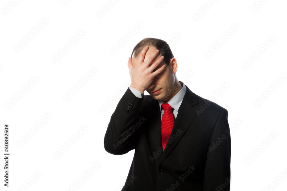 Despaired businessman with face in his palm Despaired businessman with face in his palm