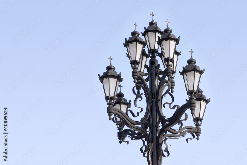 Retro styled lighting lantern over blue sky