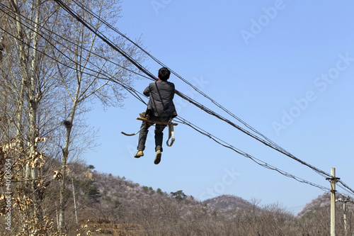 Worker fixing electrical power line, China