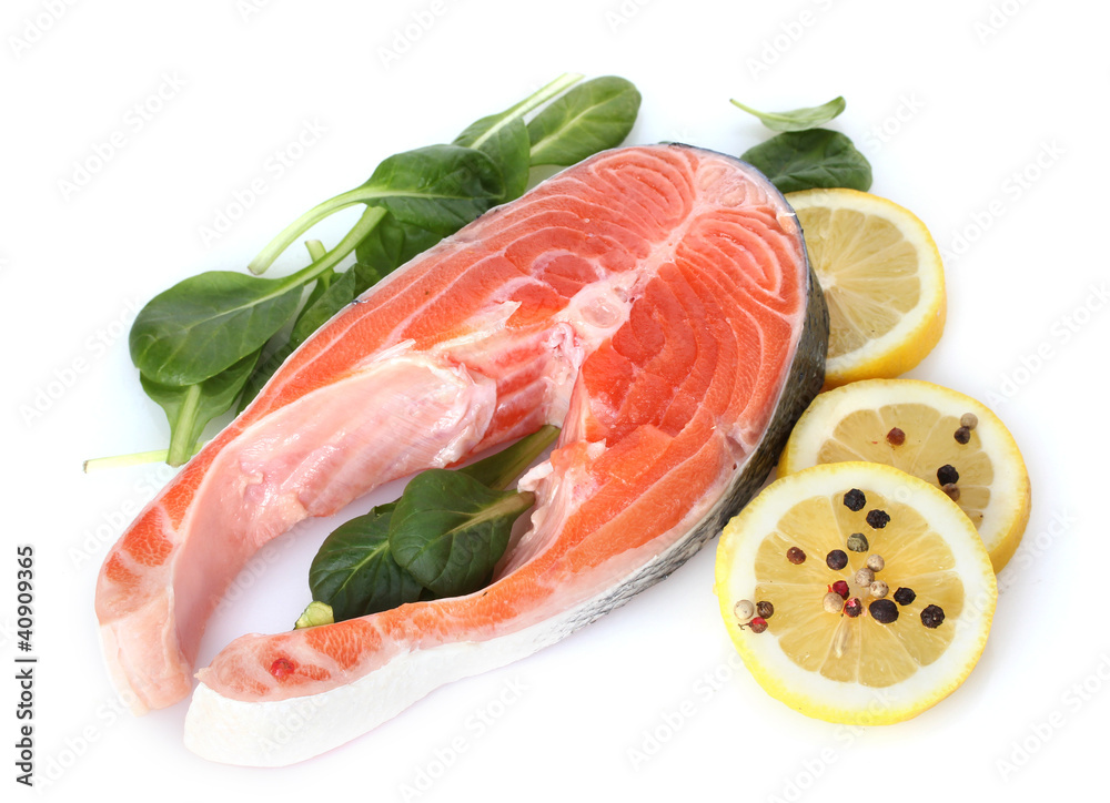 Red fish with lemon, green leaves and pepper isolated on white.