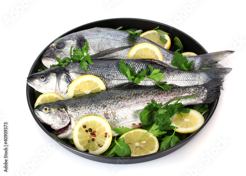 Fresh fishes with lemon, parsley and pepper