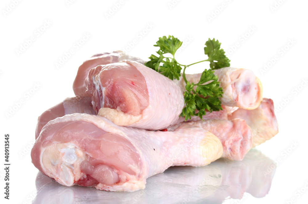 Raw Chicken Drumsticks in plate with parsley isolated on white