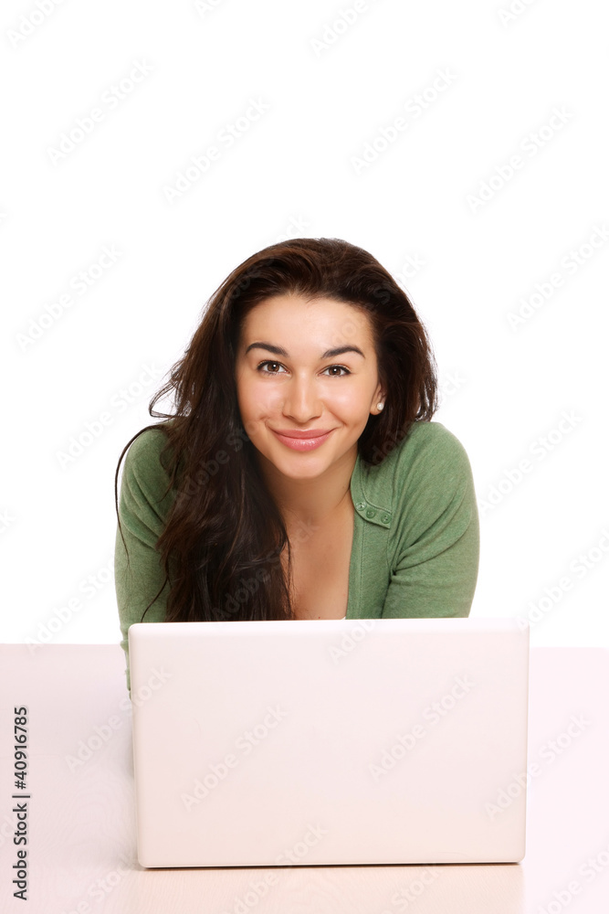 A young girl with a laptop lying on the floor A young girl with a laptop lying on the floor