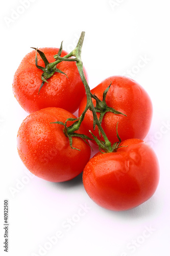 Bunch of delicious fresh tomatoes isolated on white background