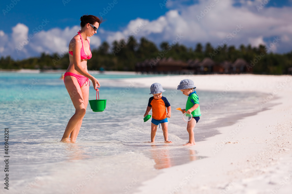 Mother and twin boys playing on the beach Mother and twin boys playing on the beach