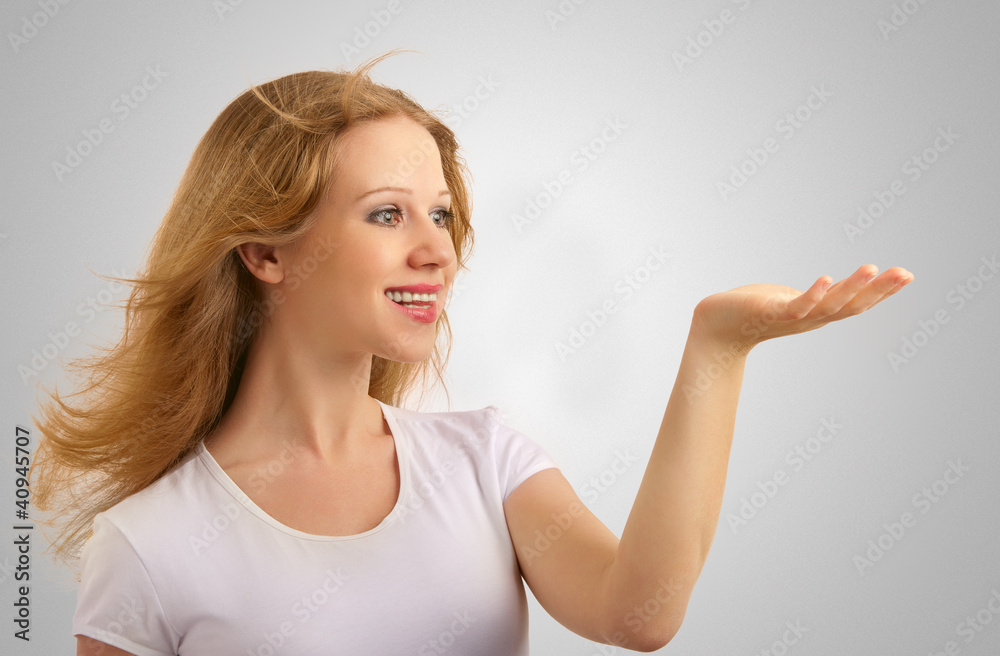 Beautiful girl gives a presentation, holding something in hands Beautiful girl gives a presentation, holding something in hands