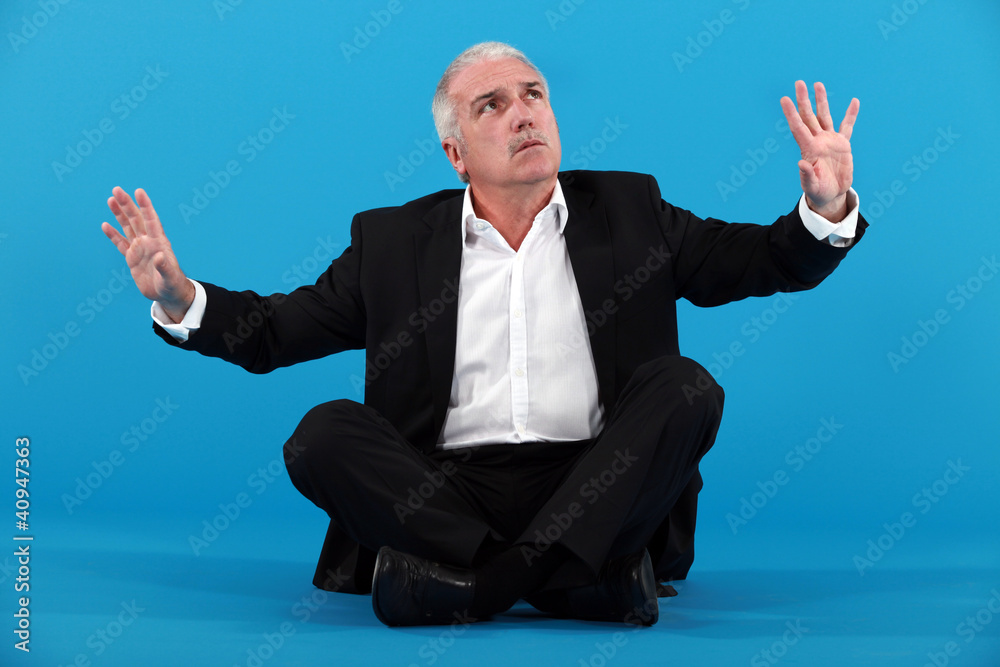 mature businessman gesturing on blue background mature businessman gesturing on blue background