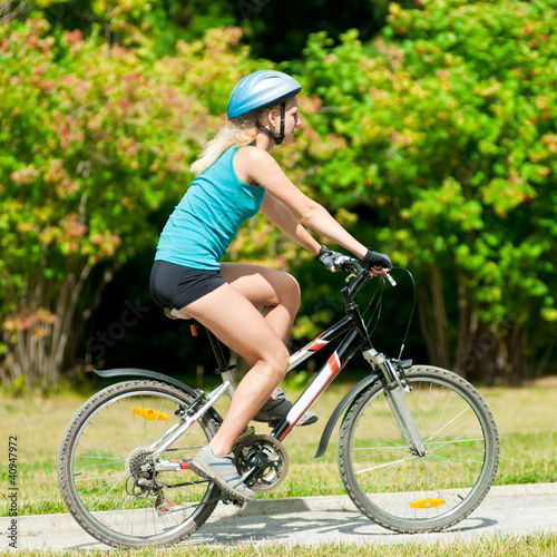 Young smiling woman on bike