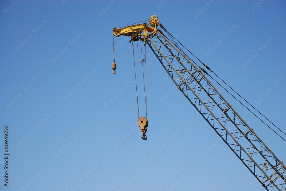 crane in a Construction site against a blue sky crane in a Construction site against a blue sky