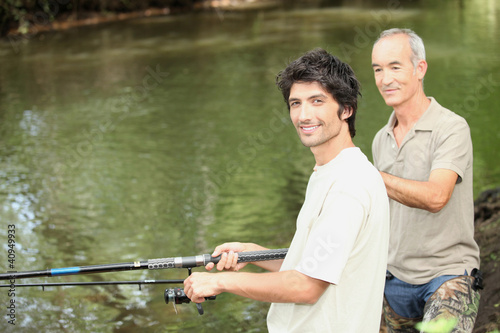Fotografia, Obraz an old man and a young man angling beside a river