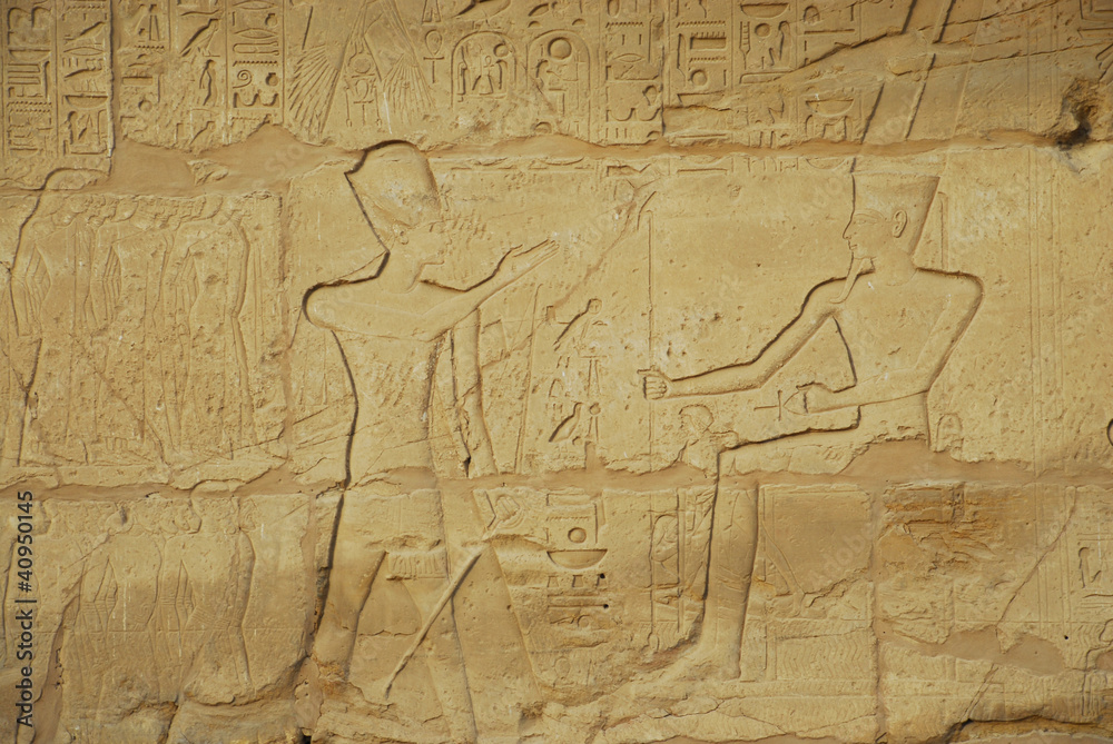 Naklejka premium Egyptian hieroglyphs engraved on stone in Horus temple, Egypt