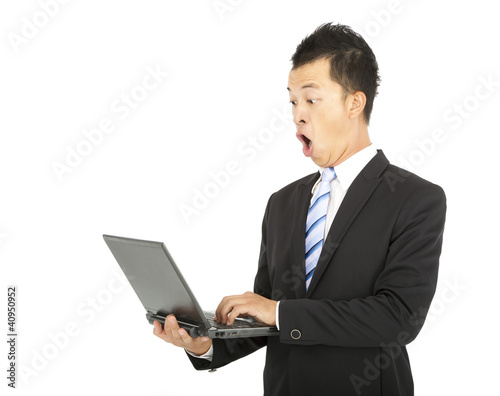 surprised businessman watching the laptop computer © Tom Wang