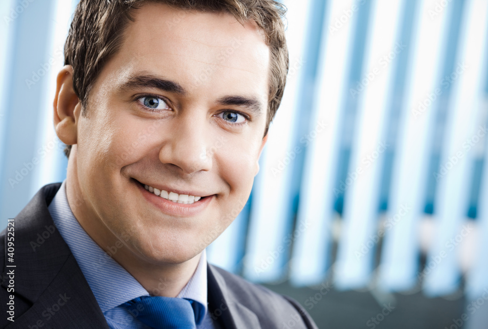 Portrait of smiling businessman at office Portrait of smiling businessman at office