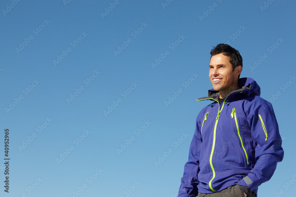 Man Standing In Snow Wearing Warm Clothes On Ski Holiday In Moun Man Standing In Snow Wearing Warm Clothes On Ski Holiday In Moun