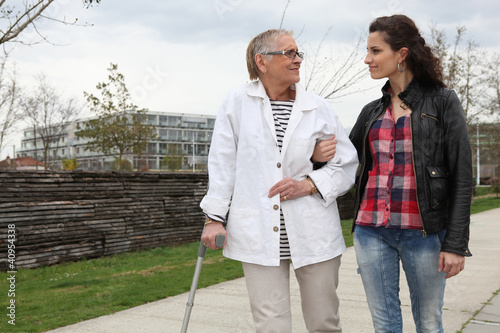 фотографія Woman strolling with an elderly lady