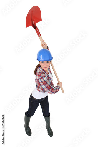 Woman holding spade over head