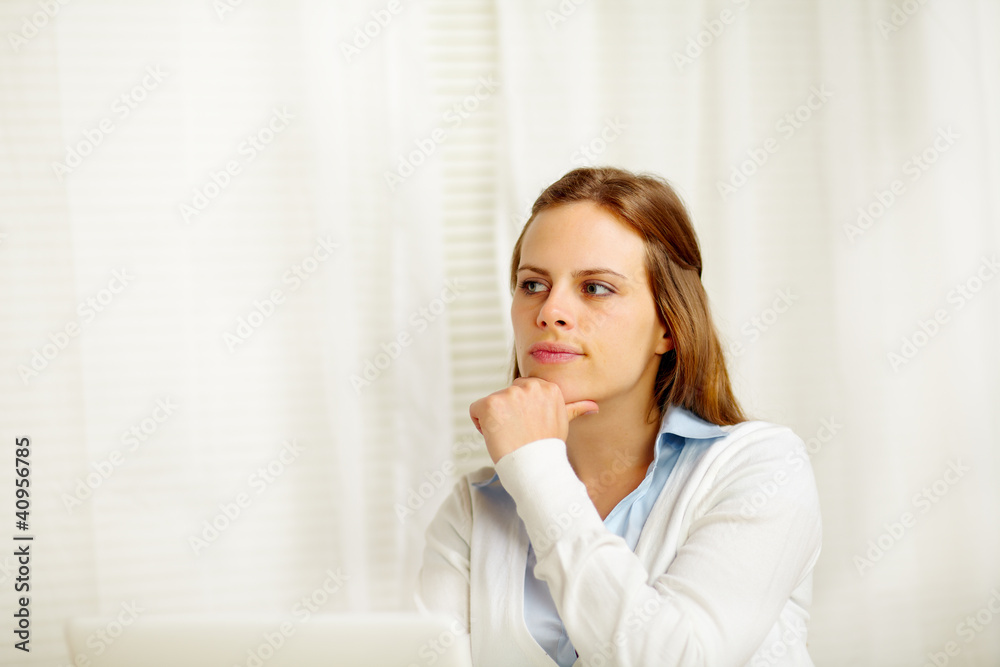 Young woman thinking in from laptop