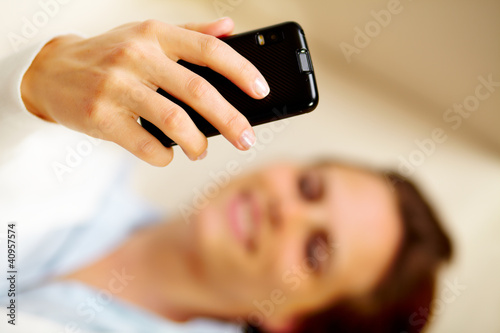 Caucasian woman using a cell phone at home