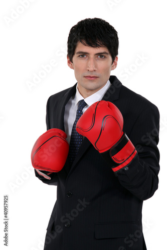 A businessman with boxing gloves. © auremar