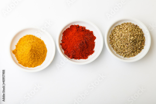 Fototapeta Naklejka Na Ścianę i Meble -  Colorful spices in white pods isolated on white
