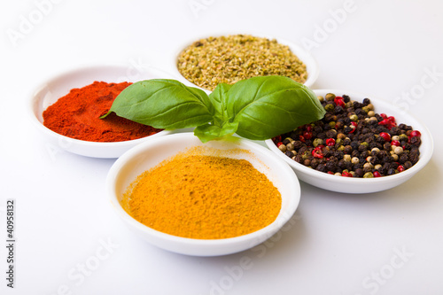 Fototapeta Naklejka Na Ścianę i Meble -  Colorful spices in white pods isolated on white