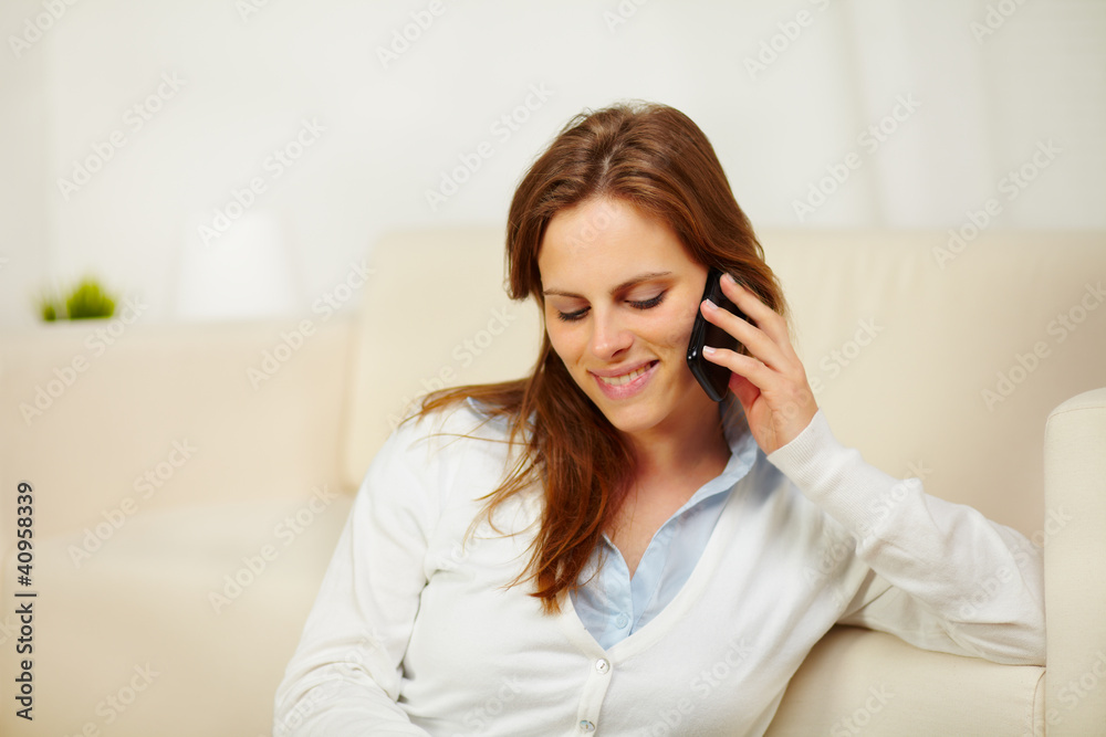 Young female enjoying conversation on cellphone Young female enjoying conversation on cellphone