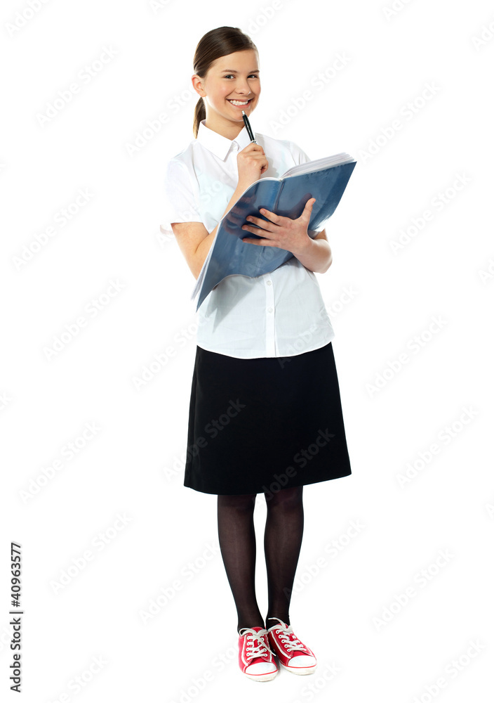 School girl thinking and smiling at camera School girl thinking and smiling at camera