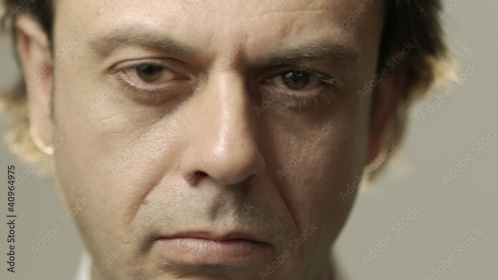 Portrait of serious caucasian adult man looking at camera