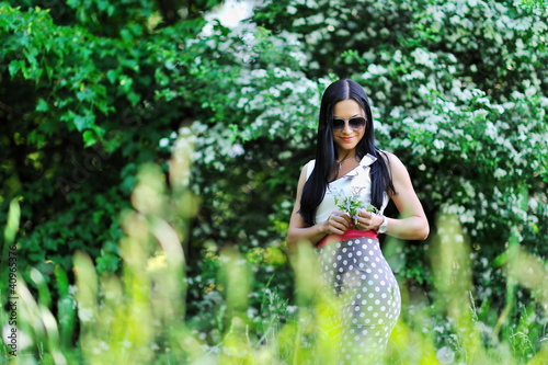 Beautiful girl posing in a green park