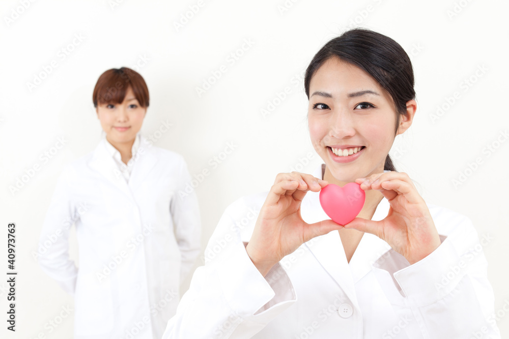 asian doctor holding a symbol of heart asian doctor holding a symbol of heart