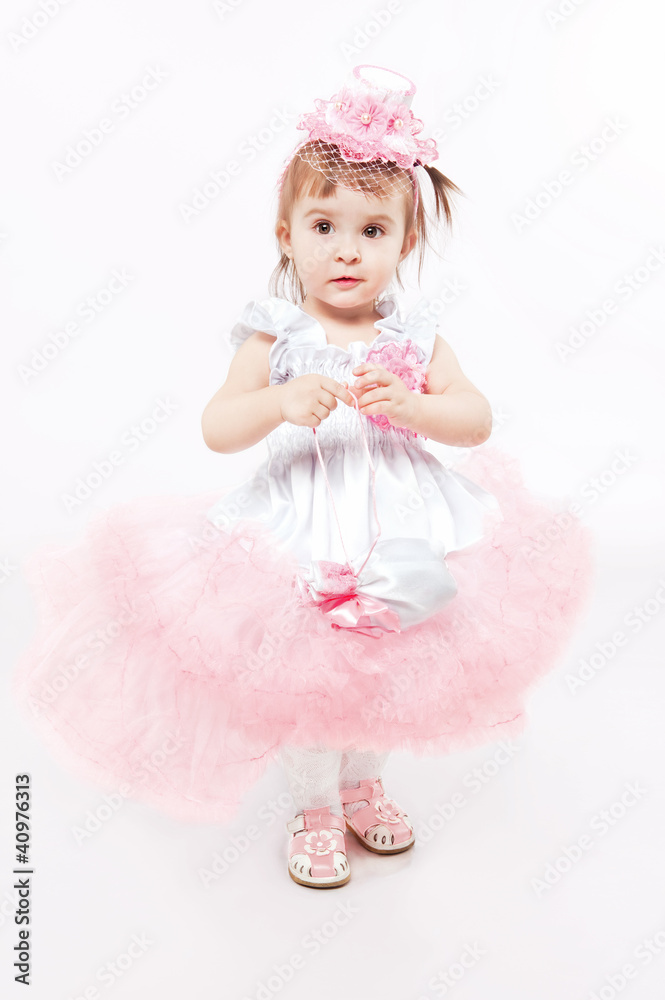 Portrait of a young girl in beautiful pink dress