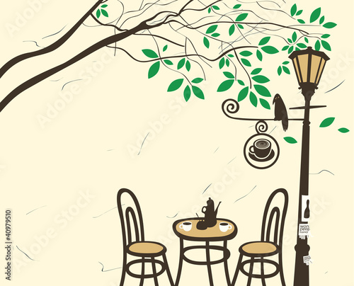 Open-air cafe under a tree with a lantern