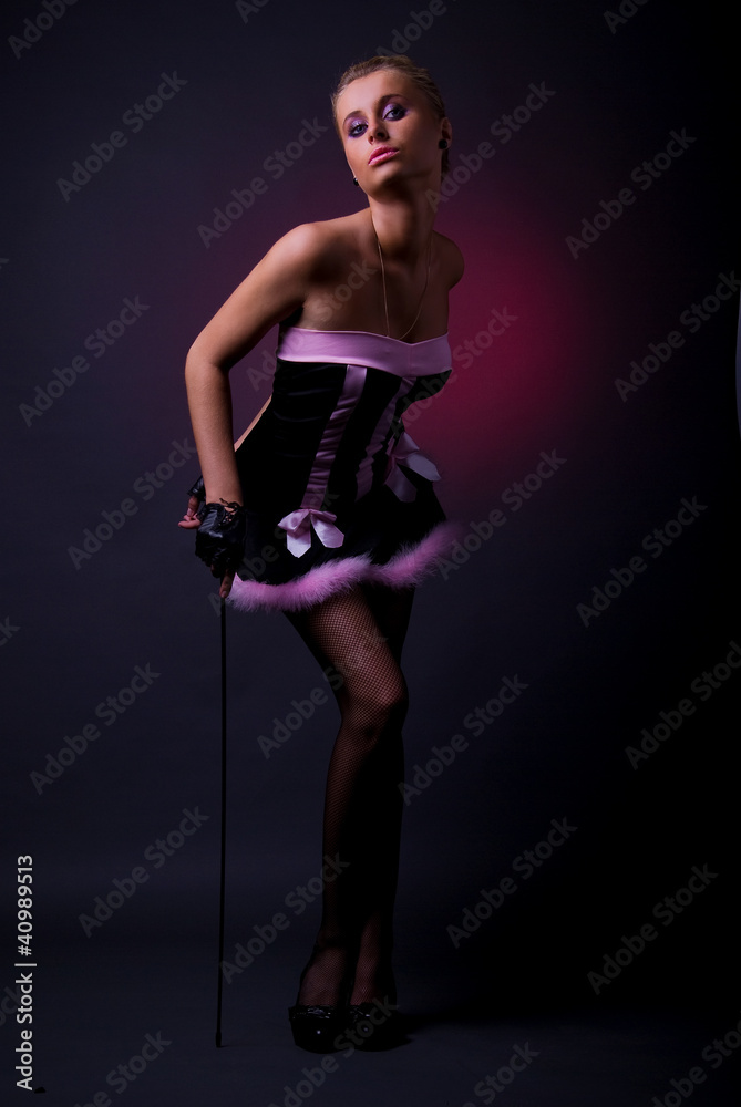 Female model posing in black and pink dress