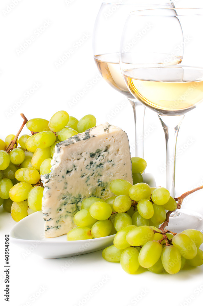 Two glasses of white wine, blue cheese and a grapes Two glasses of white wine, blue cheese and a grapes