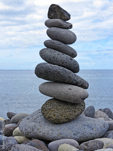 stack of pebbles on the beach and sea background